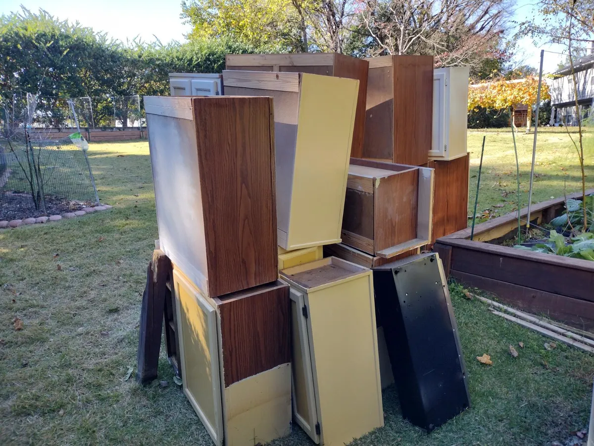Large cabinets and furniture staged for removal